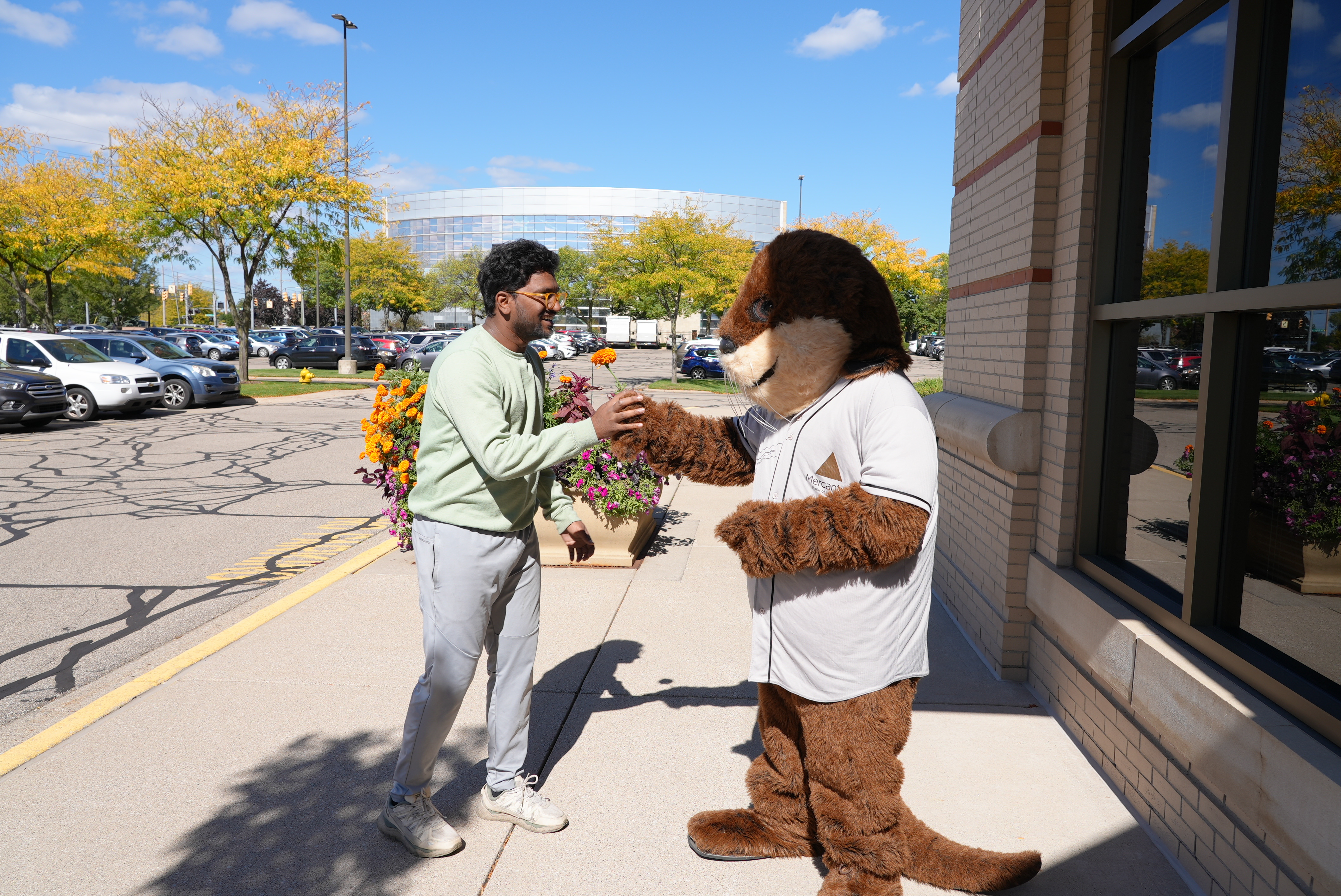 Earnie the Otter Giving a Flower - Mercantile Bank