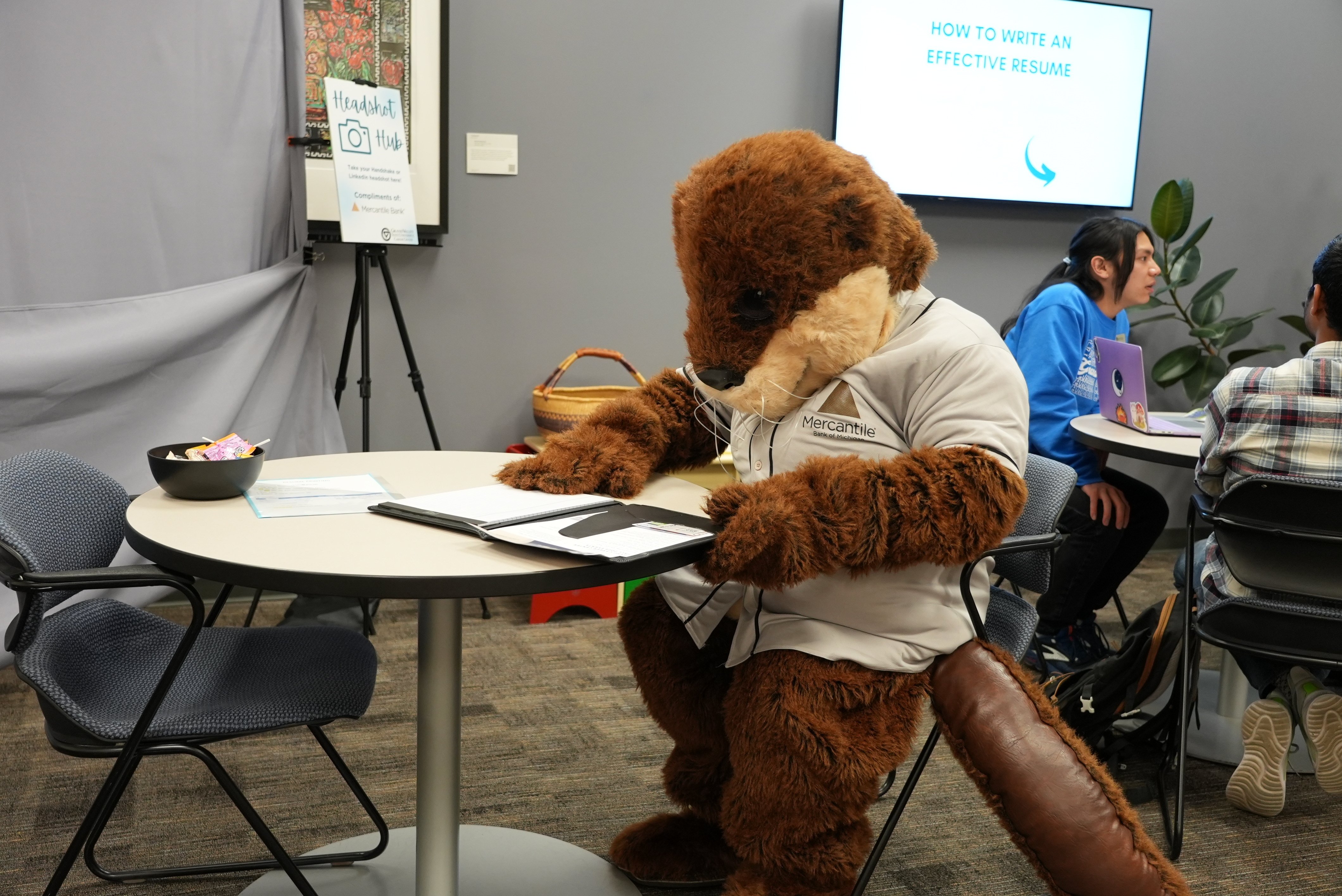 Earnie the Otter Studying - Mercantile Bank